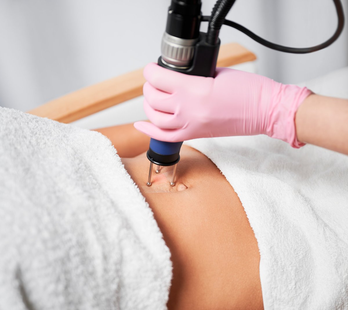 Close up doctor using ablative laser machine performing lifting procedure